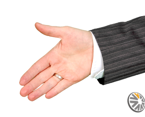 A business man extends his hand to shake yours